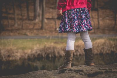 Low section of girl standing outdoors