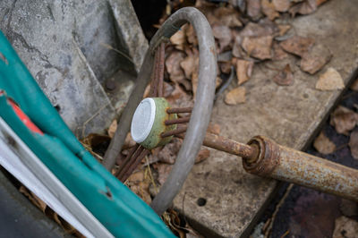 High angle view of rusty steering wheel in abandoned car