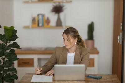 Woman working at home with laptop. home office.  notebook for working. 