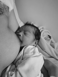 Close-up of cute baby boy sleeping on bed