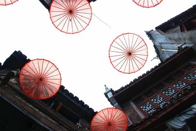 Low angle view of lanterns against clear sky