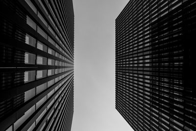 Low angle view of a building canyon against clear sky