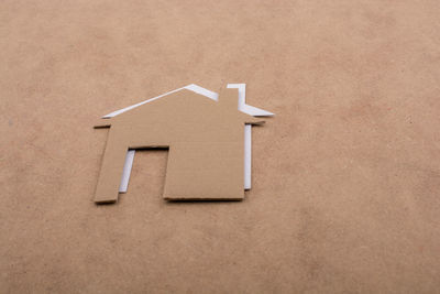 High angle view of house shape cardboard on table