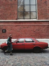 Vintage car on street against building in city