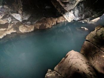 Scenic view of rocks in river against sky