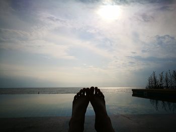 Low section of woman relaxing on beach