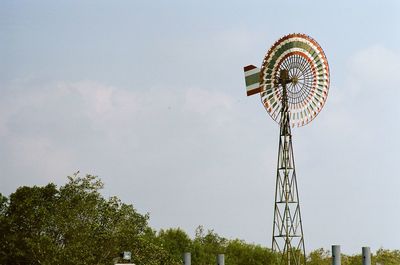 Low angle view of ferris wheel against sky