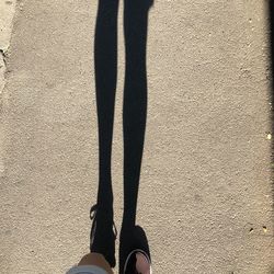 Low section of woman standing on shadow