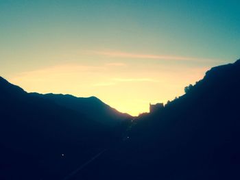 Scenic view of mountains against sky at sunset