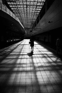 Silhouette people walking in corridor
