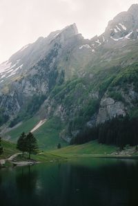 Scenic view of lake and mountains against sky