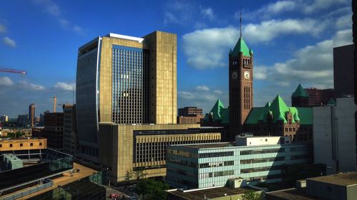 Modern buildings against cloudy sky