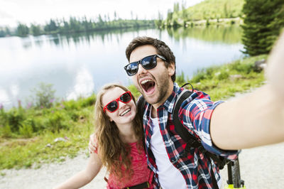 Young couple taking selfies on a bicycle trip