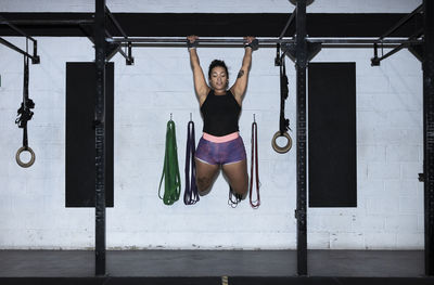 Full length of woman exercising in gym