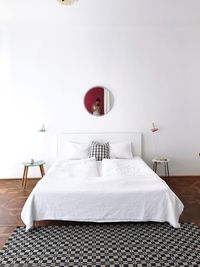 Mid adult woman reflecting in mirror on wall at bedroom