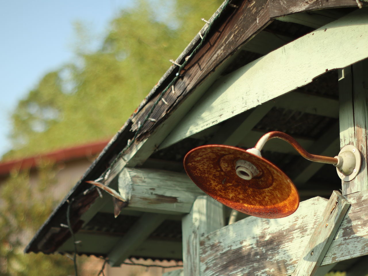 LOW ANGLE VIEW OF RUSTY METAL HANGING ON WOOD