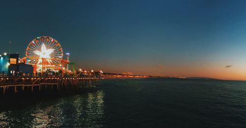 Illuminated ferris wheel at night