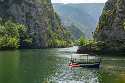 Scenic view of river amidst mountains