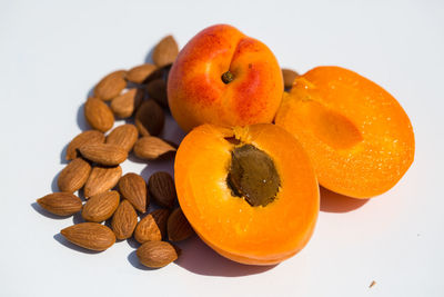 Close-up of orange fruits over white background