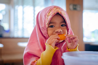 Close-up of young woman drinking juice