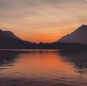 Scenic view of calm sea against orange sky