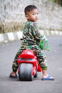 Portrait of boy standing on road