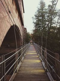 View of footbridge against sky