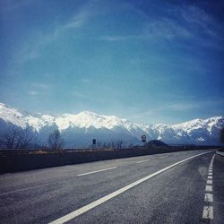 Scenic view of snowcapped mountains against cloudy sky