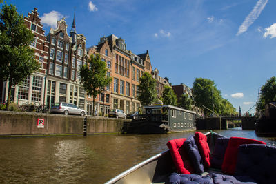 People by boat in river against sky