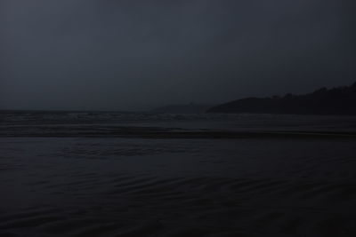 Scenic view of sea against clear sky at night