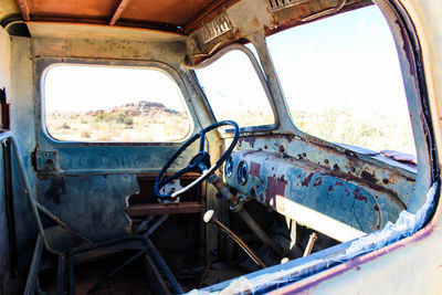 Abandoned car against sky