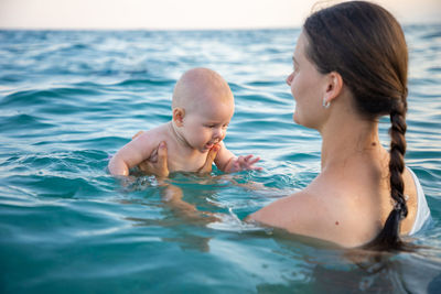 Mother with daughter in sea