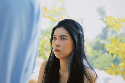 Portrait of young woman looking away