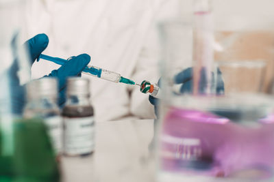 Scientist in laboratory hands holding vaccine