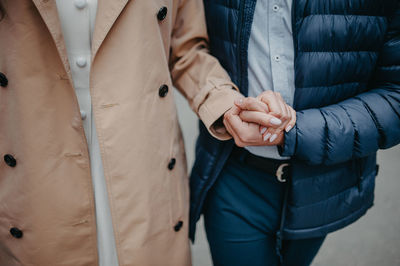 Man and woman with long nails hold each other very tightly