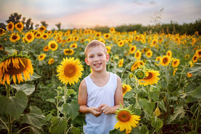 Portrait of smiling girl on sunflower field