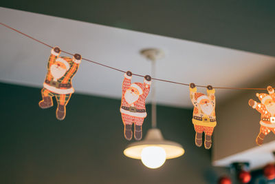 Low angle view of clothespins hanging on rope against sky