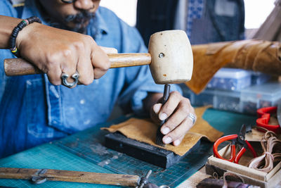 Side view of man working on table