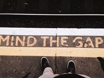 Low section of man standing on footpath