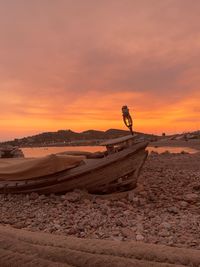 Man on beach against sky during sunset