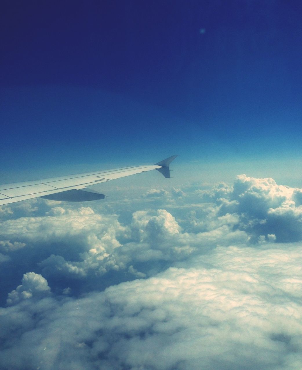 airplane, flying, air vehicle, transportation, blue, sky, mid-air, mode of transport, scenics, aircraft wing, aerial view, beauty in nature, cloud - sky, nature, cloudscape, journey, tranquility, travel, tranquil scene, on the move