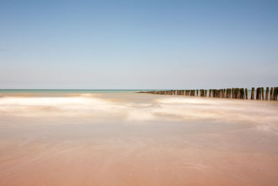 Scenic view of beach against clear sky