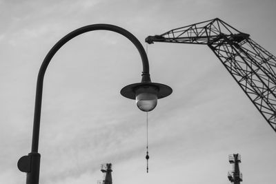 Low angle view of crane against sky