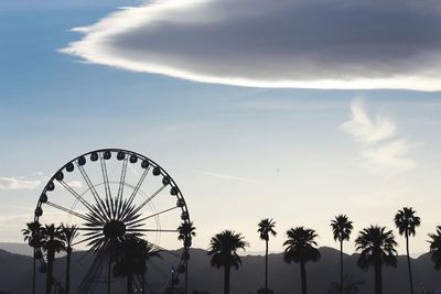 Low angle view of ferris wheel against sky