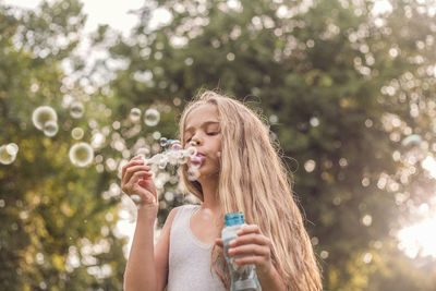 Portrait of a beautiful young woman drinking water