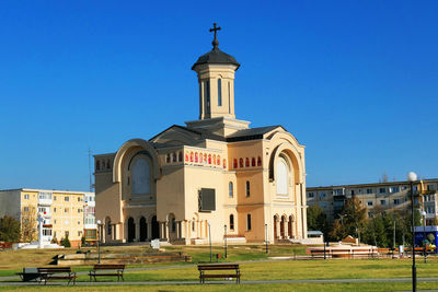 Low angle view of buildings against clear blue sky