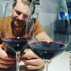 Midsection of man drinking beer in glass