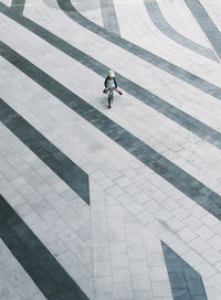 High angle view of boy riding bicycle on footpath