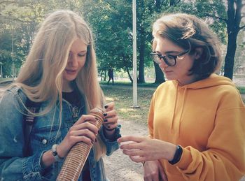 Friends having biscuits at park