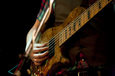 Midsection of person playing guitar